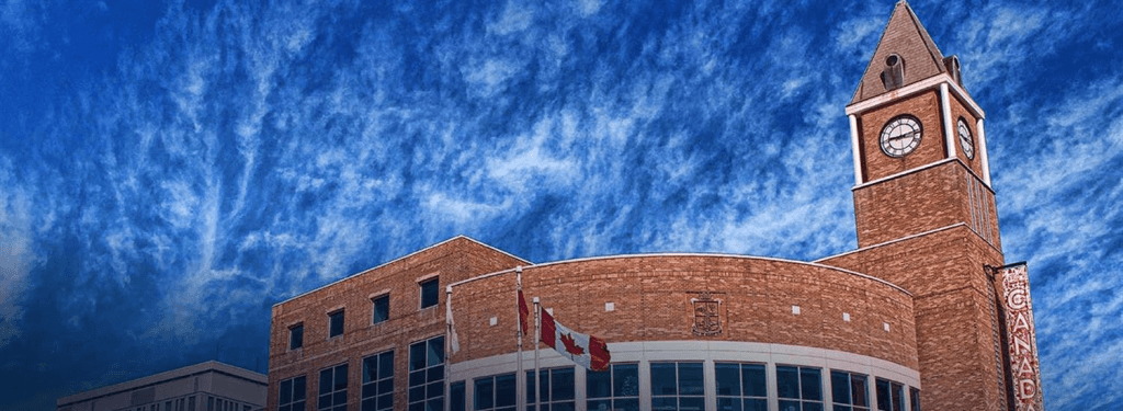 brick-building-clock-tower-canadian-flags
