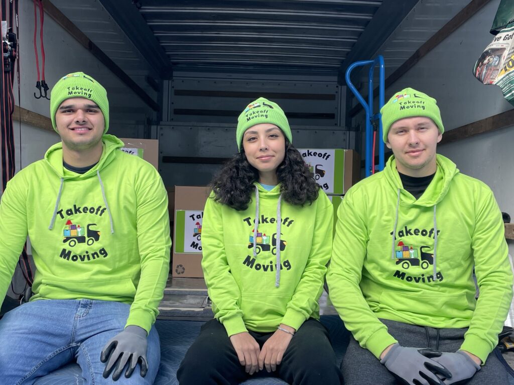 Takeoff Moving team in branded hoodies and beanies with boxes in a moving truck Takeoff-Moving Toronto