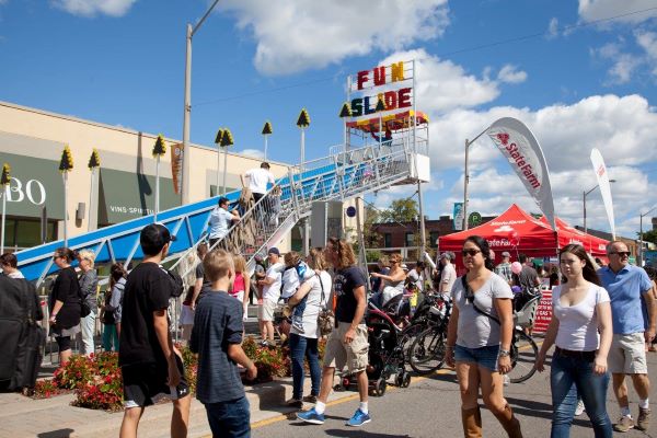 Fun Slide at an Etobicoke street festival, people enjoying activities. Takeoff-Moving Toronto